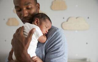 Father holding small baby